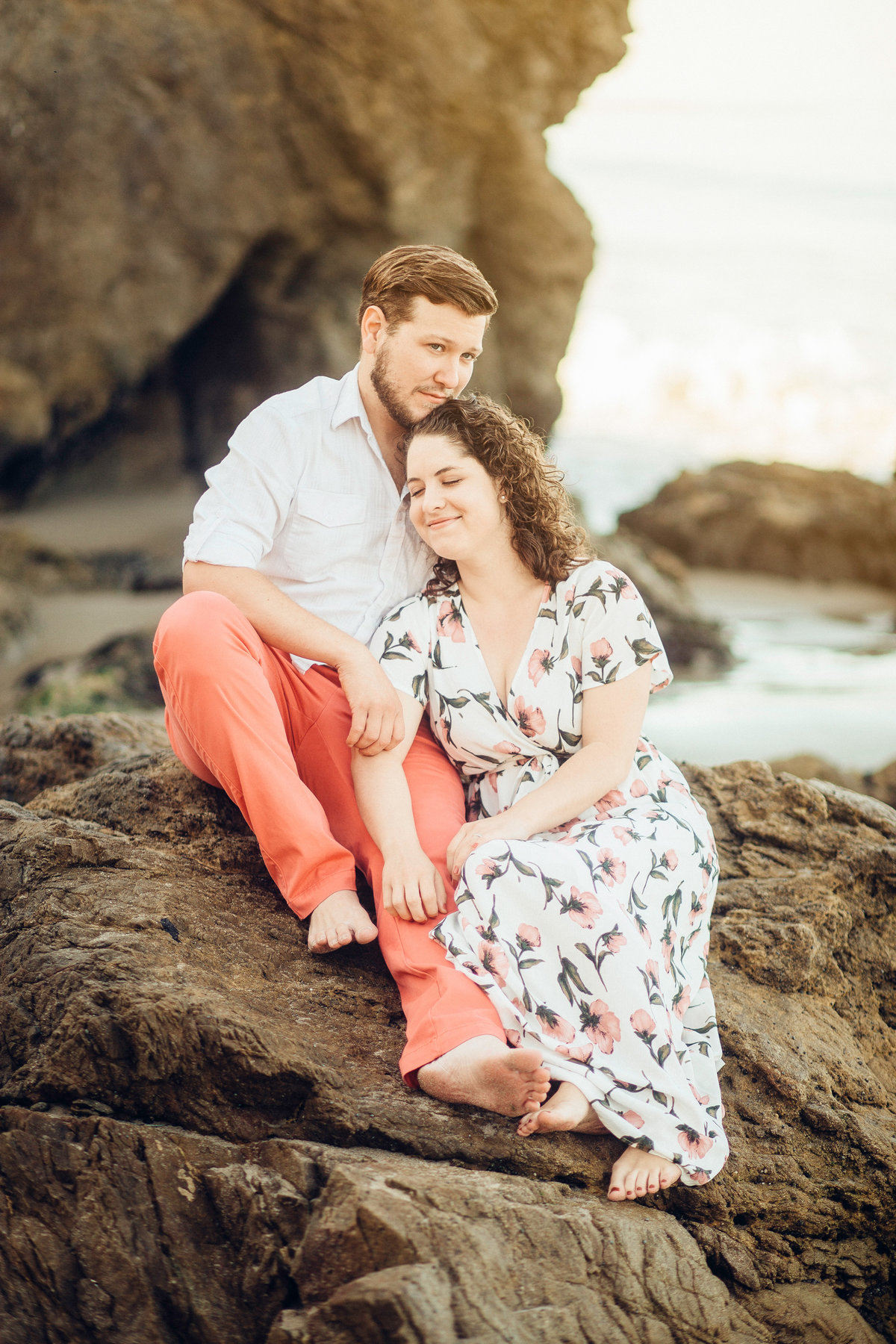 Engagement Photograph Of  Man In White Polo And Woman In Floral Dress Los Angeles