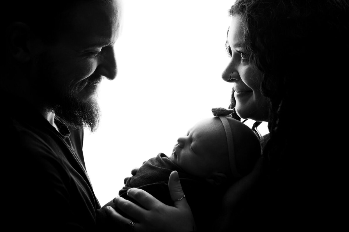Black and white backlit silhouette newborn and family studio pose