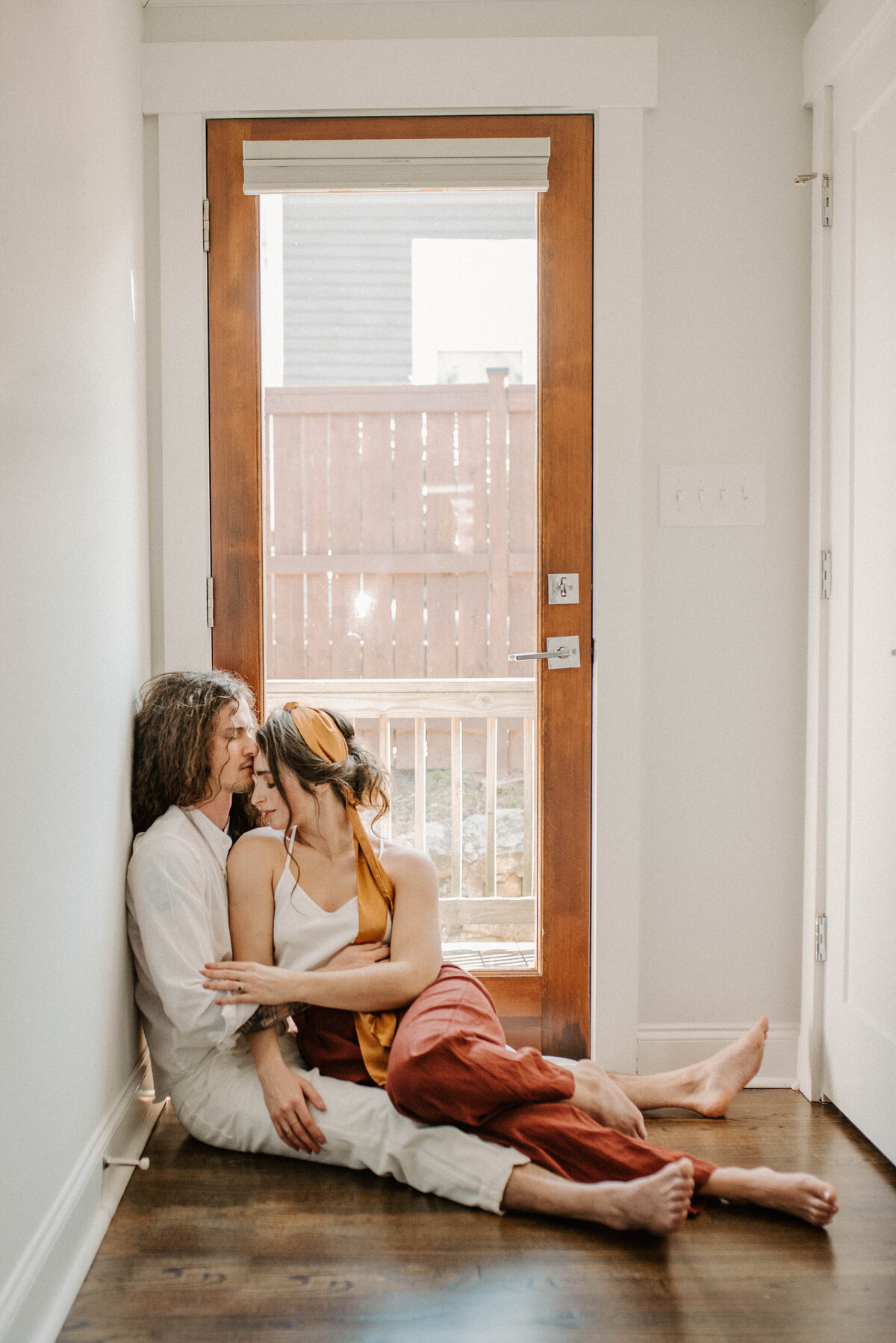 A couple sitting in front of a door