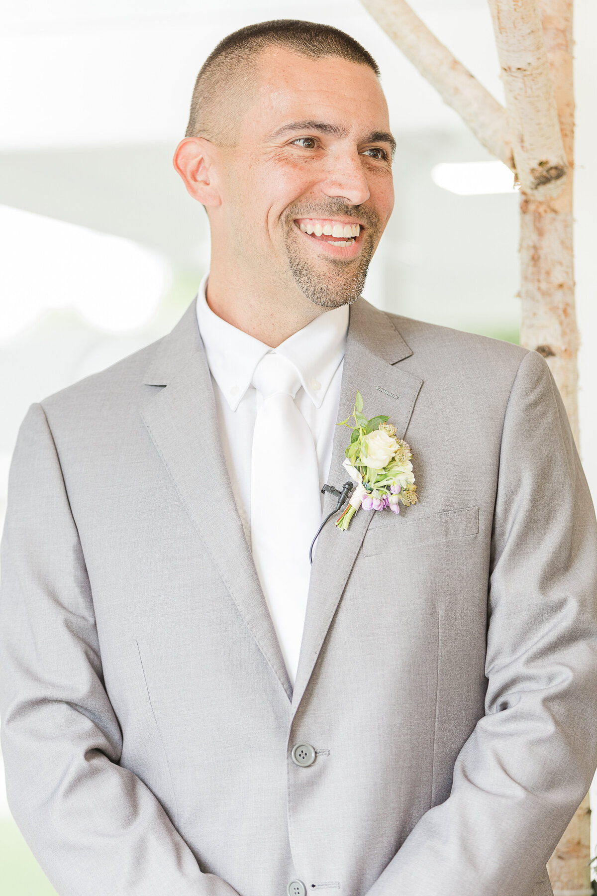 Groom is captured smiling as he sees his bride walk down the aisle.