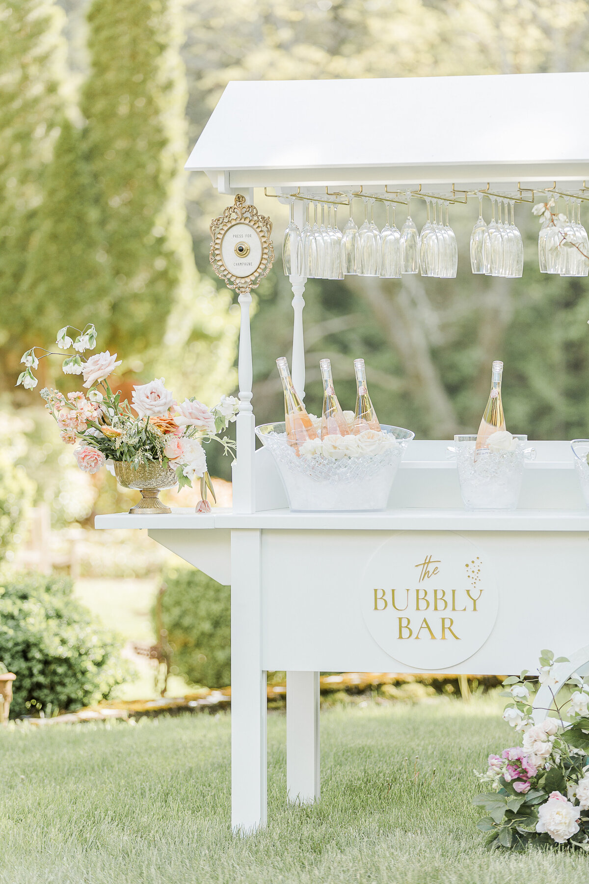 Wedding reception details featuring a Bubbly Bar cart and florals. Captured by Lia Rose Weddings