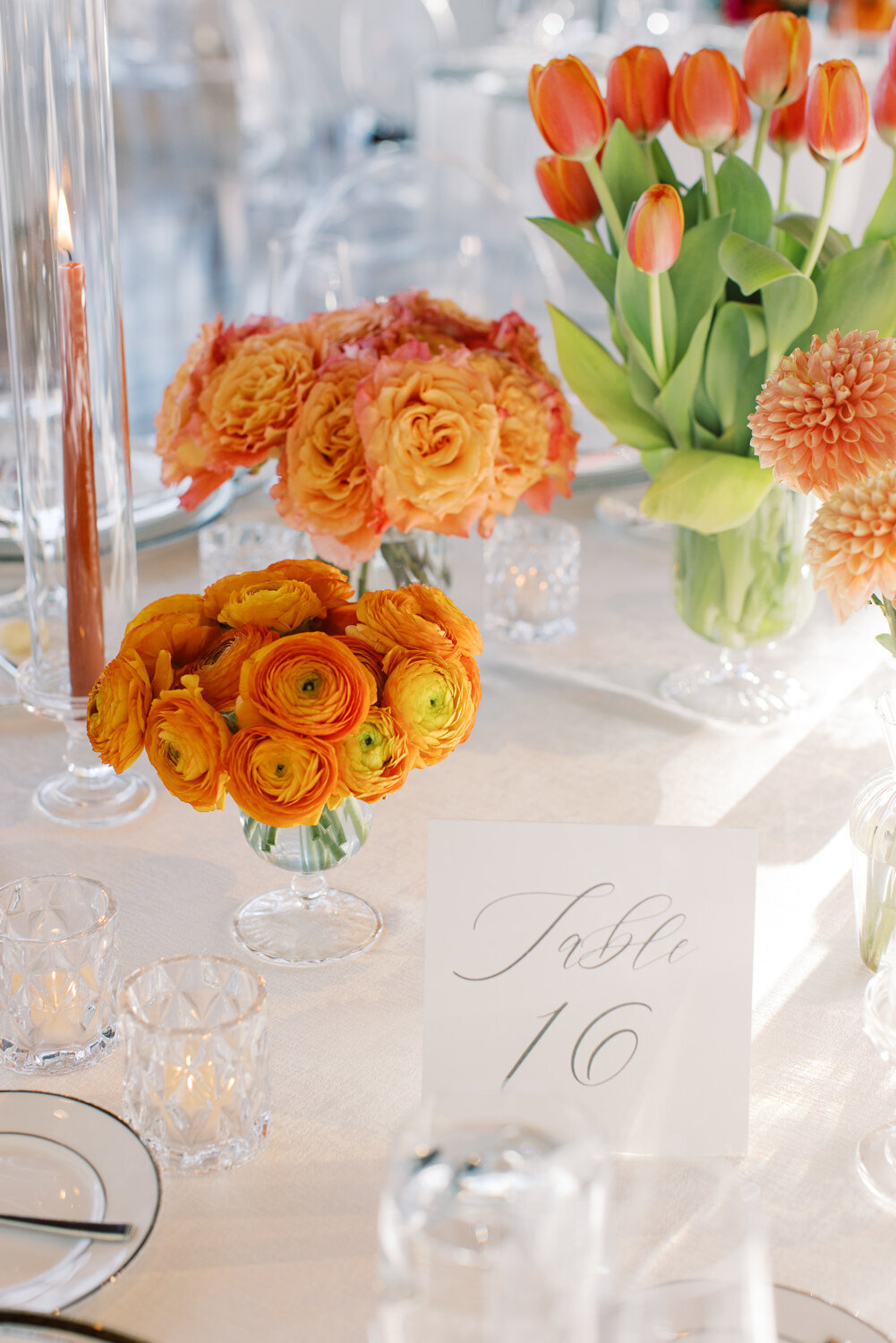 orange and tangerine wedding centerpieces with ranunculus, roses, dahlias and tulips