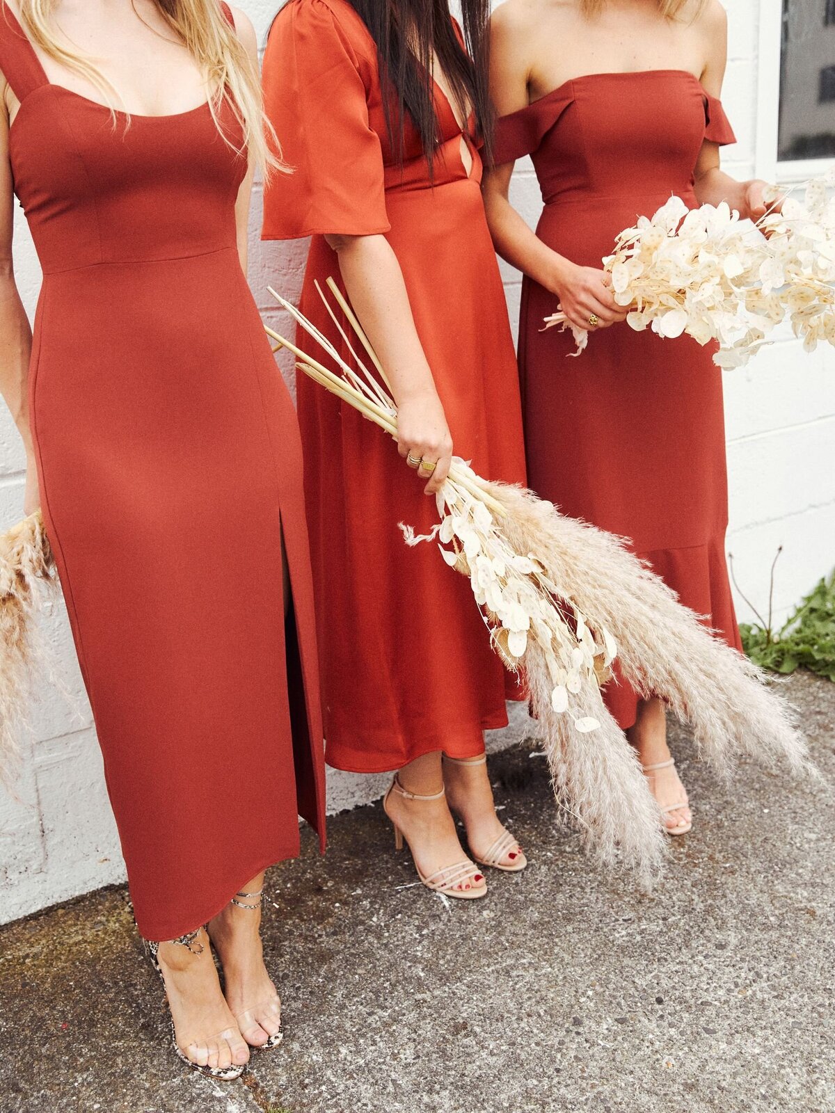 Rust bridesmaid dresses from Park & Fifth, a modern bridal boutique based in Calgary, Alberta. Featured on the Brontë Bride Vendor Guide.