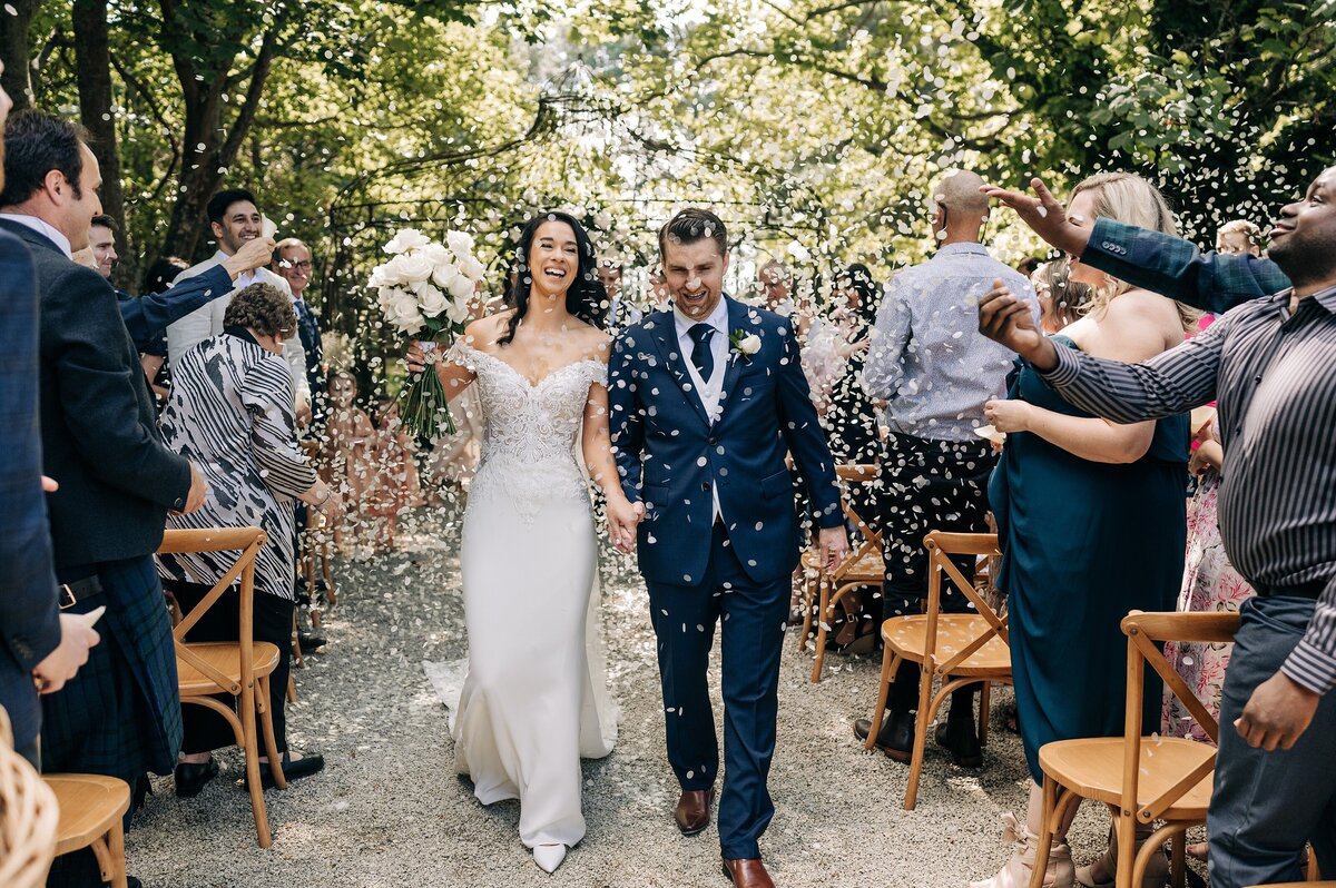 bride and groom exit ceremony down the aisle at trents vineyard with white biodegradable confetti