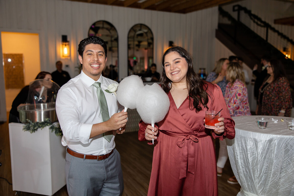 wedding guest couple enjoys cotton candy served by Sugar Clouds
