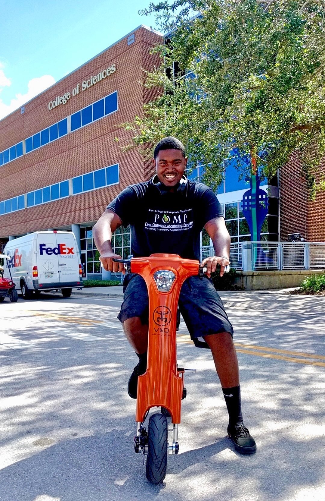 College student riding on campus on a Bronze Go-Bike M1
