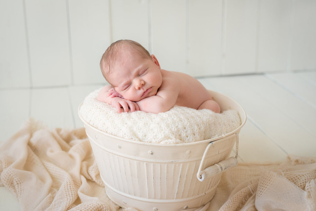 a little newborn girl in a basket