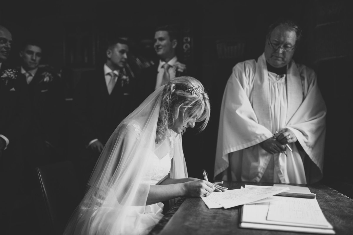 bride signing wedding register