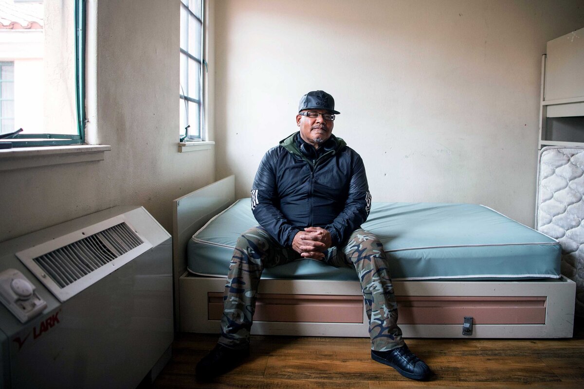 A resident at Father Joes Villages sits on bed