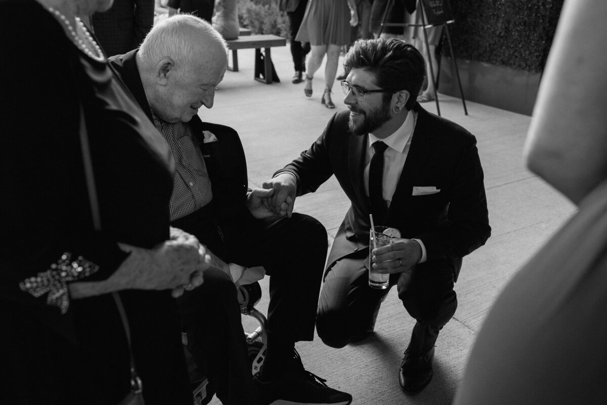 groom shares a moment with grandfather after the ceremony