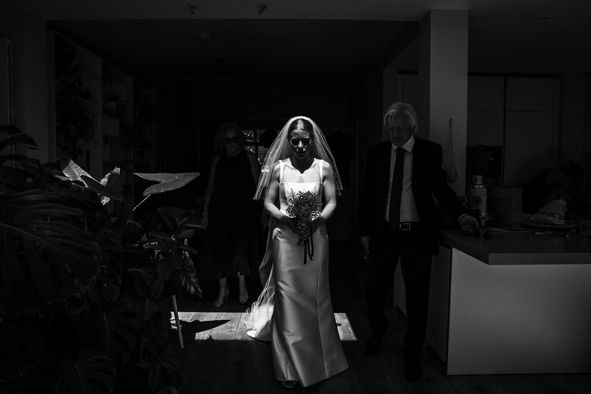 Dramatic black and white photo of bride in veil