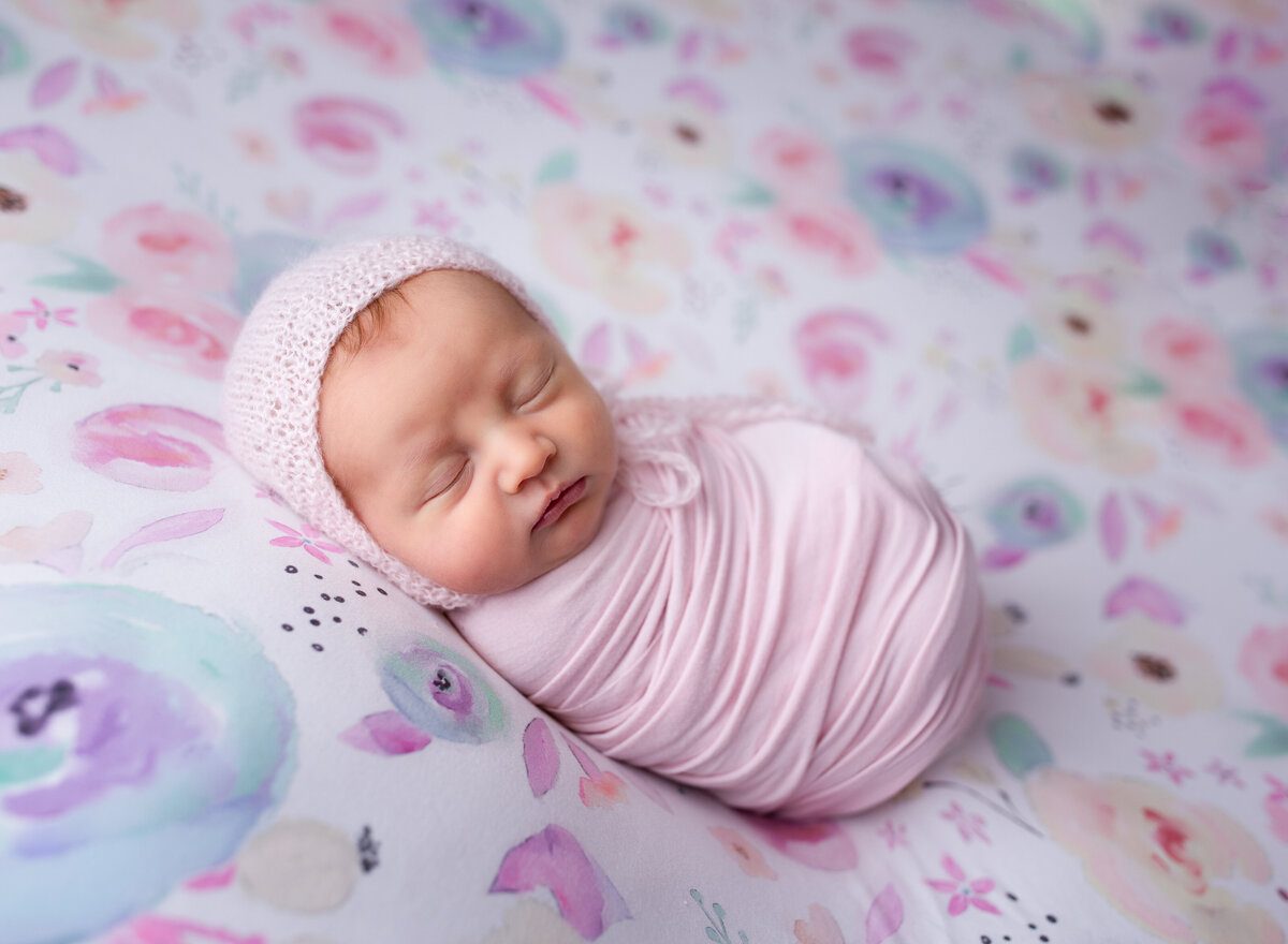 A perfect baby girl on a floral backdrop. Newborn photo by Diane Owen.