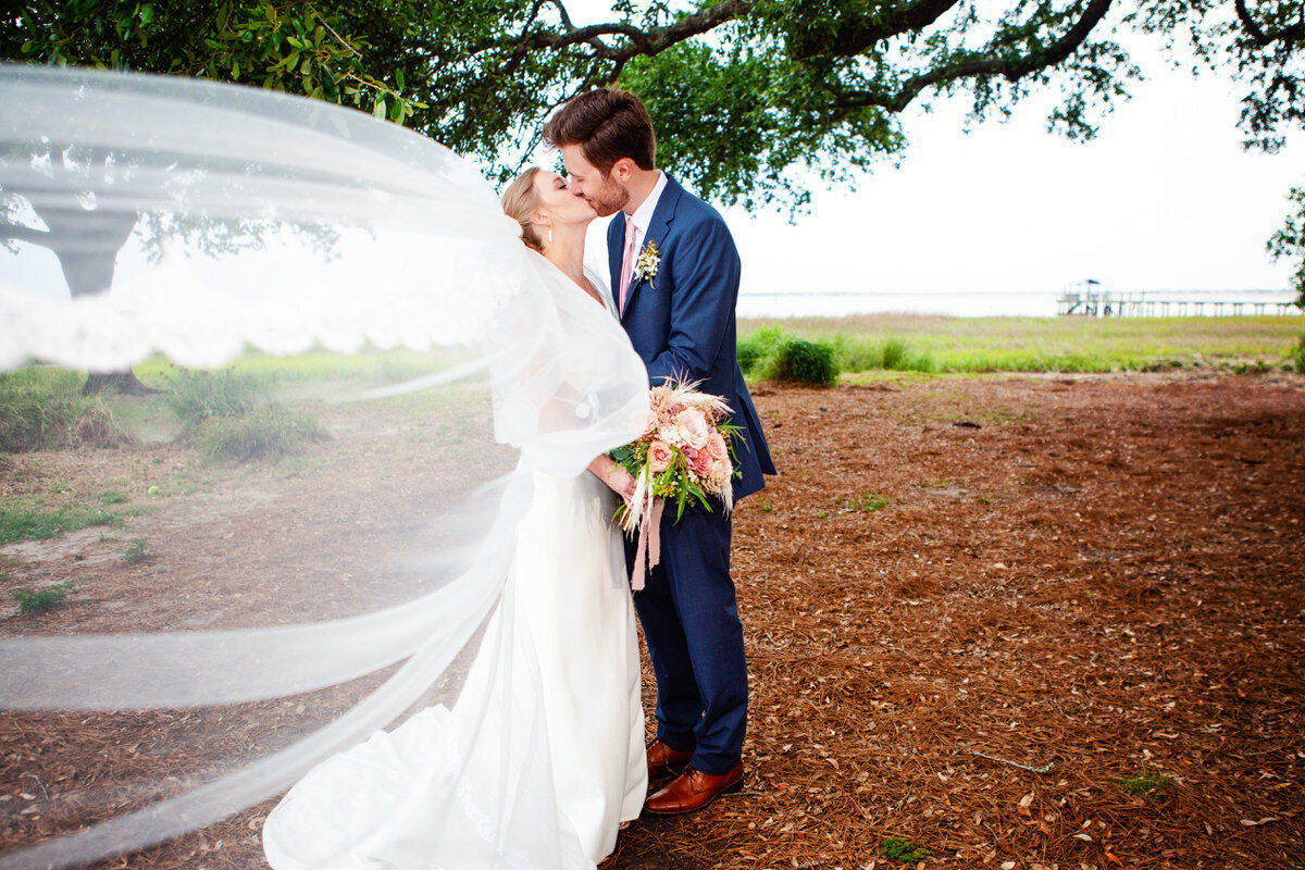 Charleston Wedding Photographer Bride and groom kiss at Alhambra Hall in Mount Pleasant