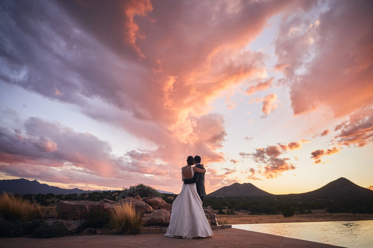 Wedding couple standing at sunset