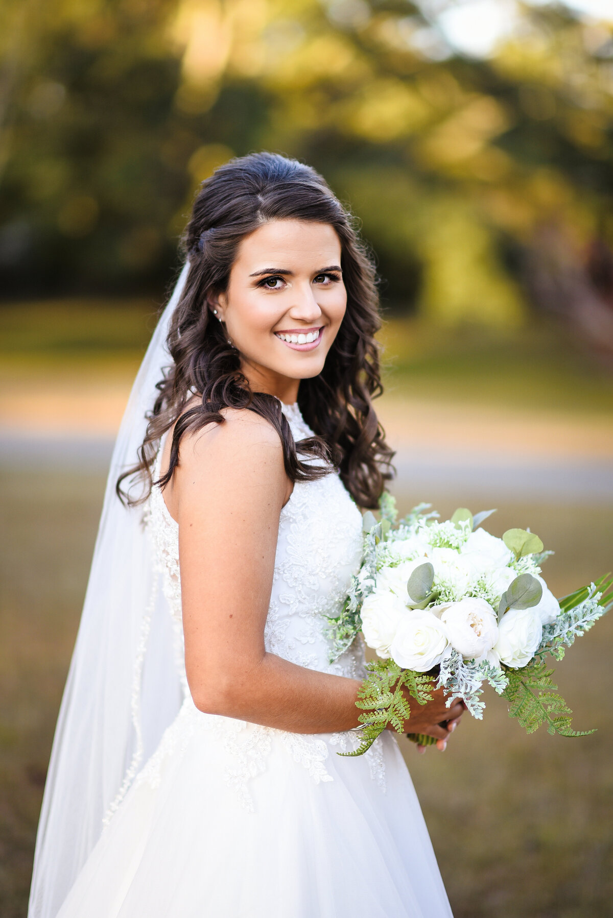 Beautiful bridal portrait photography: Bride turns to the camera outdoors in Mississippi