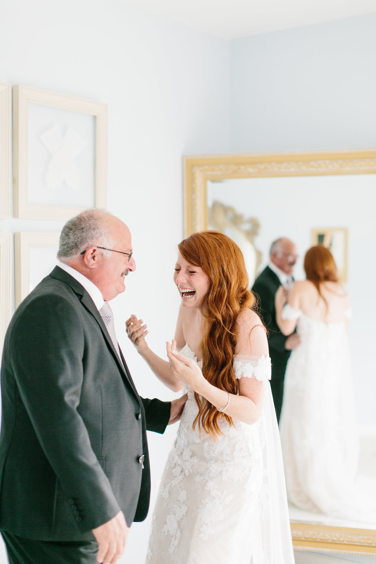 bride laughing and smiling seeing father for first time