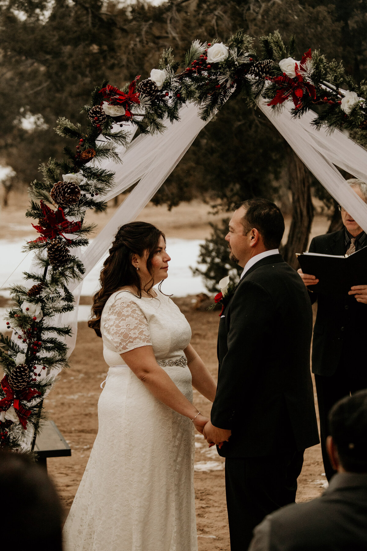 bride and groom exchanging vows at backyard intimate wedding
