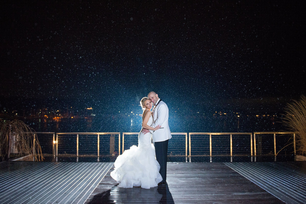 Bride and groom outside while it rains at Harbor Club at Prime