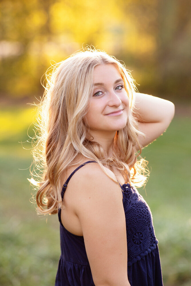 Senior session of young woman wearing a purple top