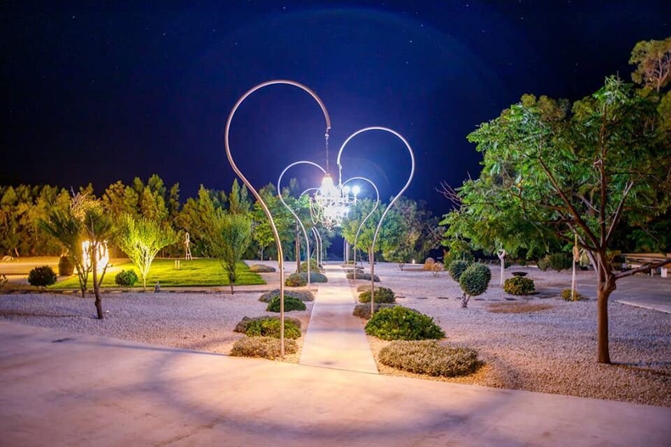 A bespoke lighting structure creates the illusion of a heart at the entrance of the venue
