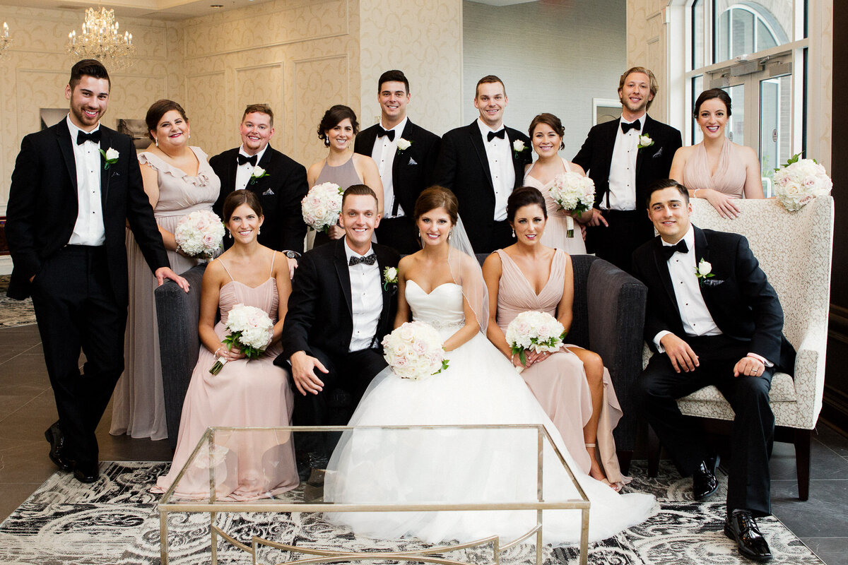 Bridal party sitting in reception room on wedding day in Buffalo, New York