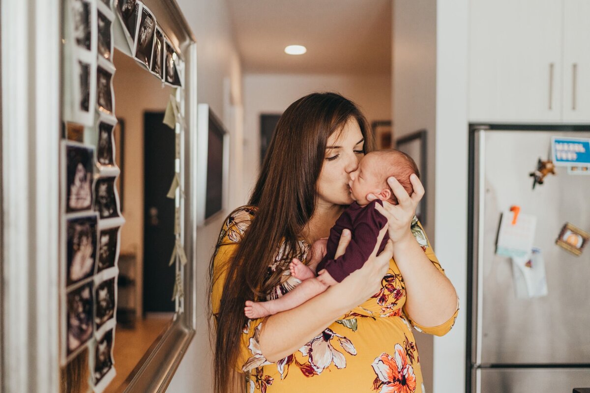 mom-kissing-on-newborn-baby-in-her-seattle-home