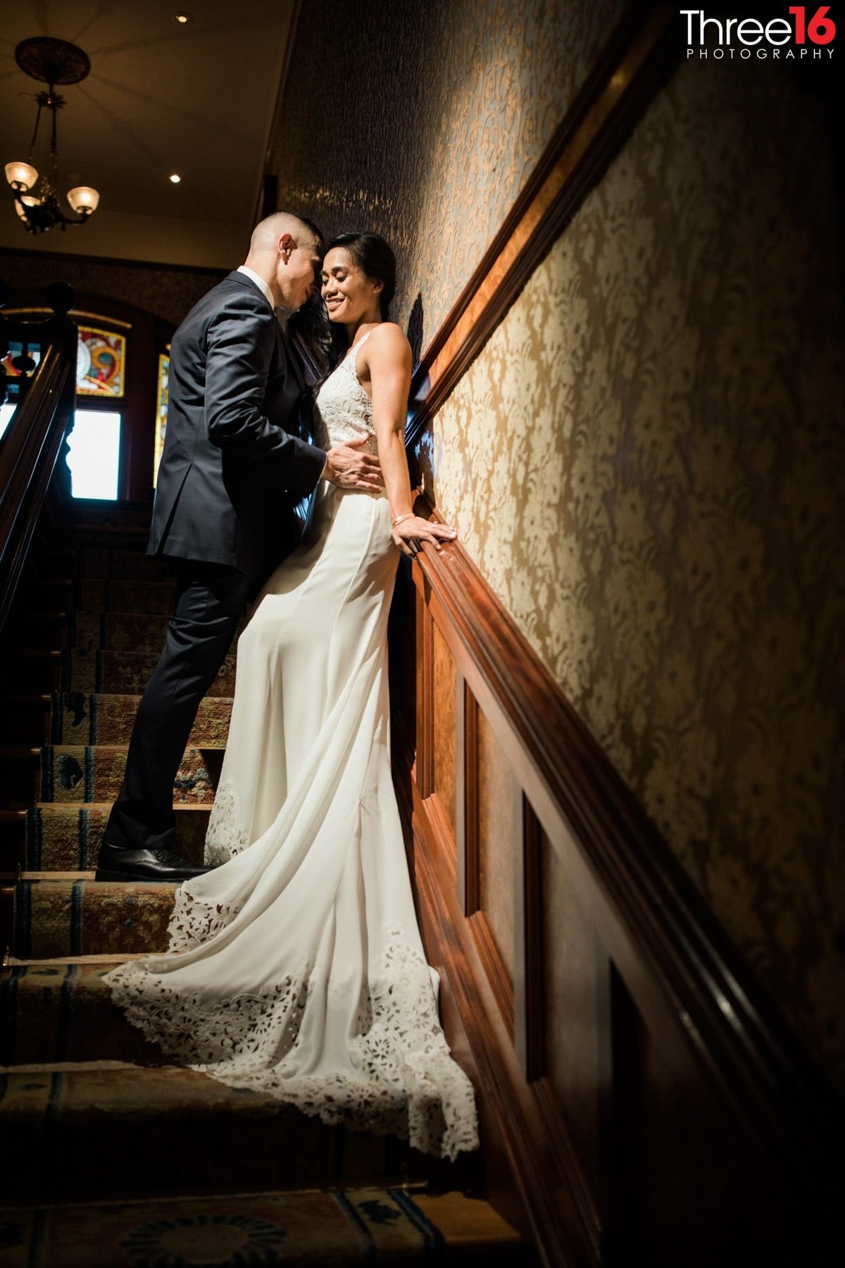 Intimate moment for Bride and Groom against the staircase railing