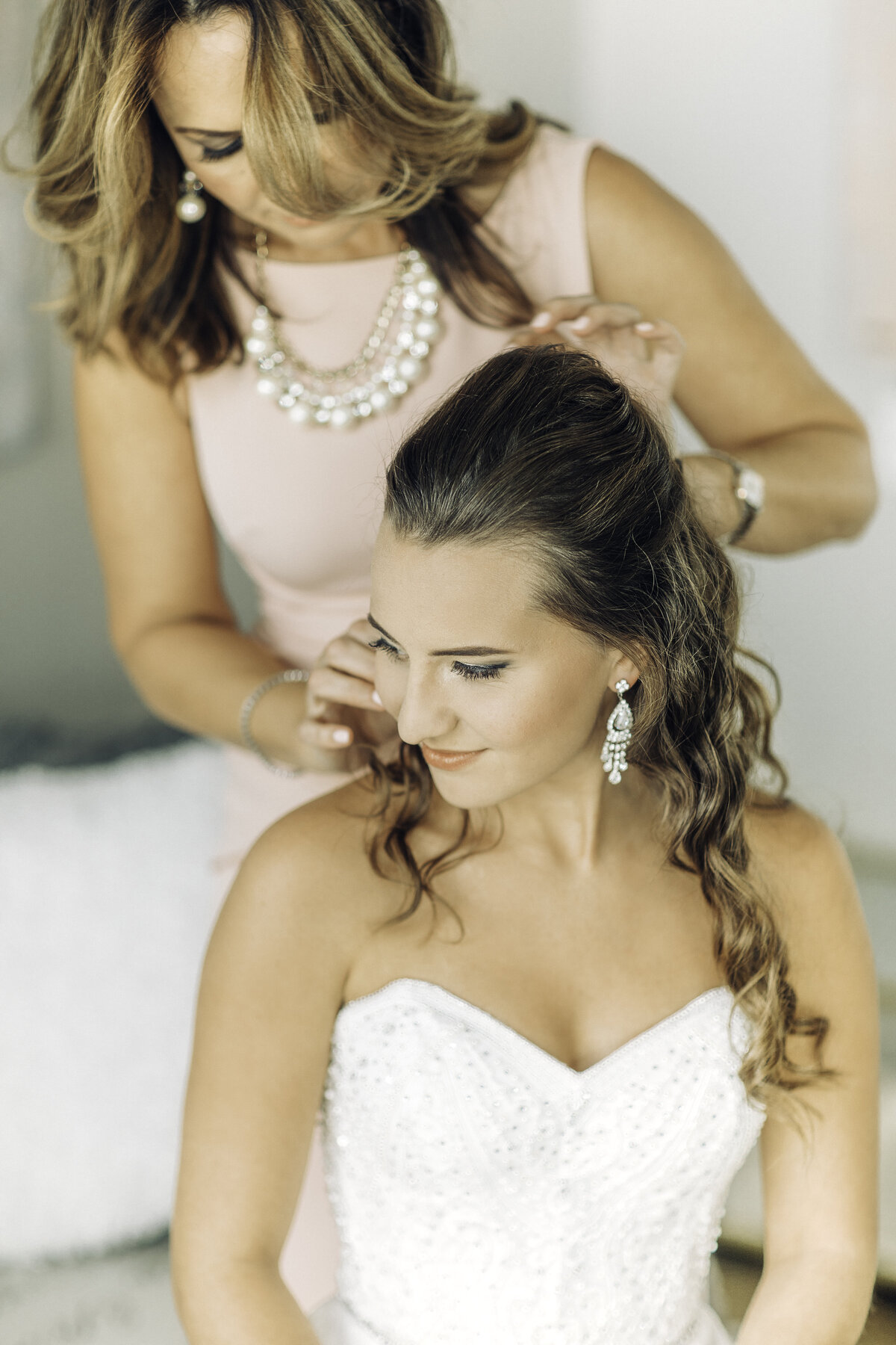 Wedding Photograph Of Woman Fixing Bride's Hair Los Angeles