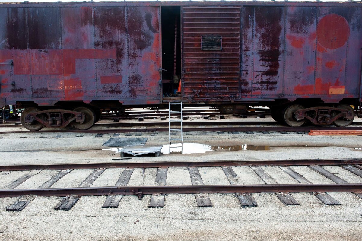 purple train car with door open and step ladder