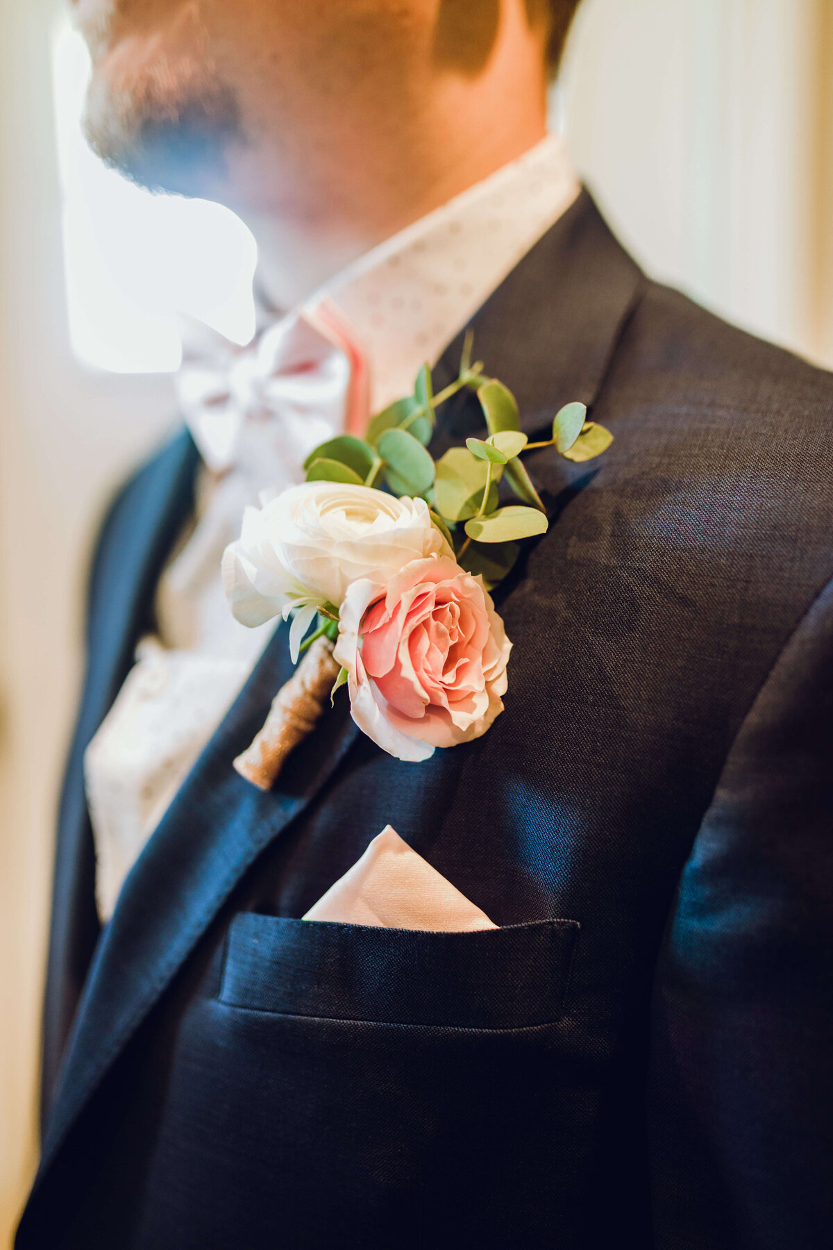 groom pocket square, suit & flowers closeup before intimate wedding