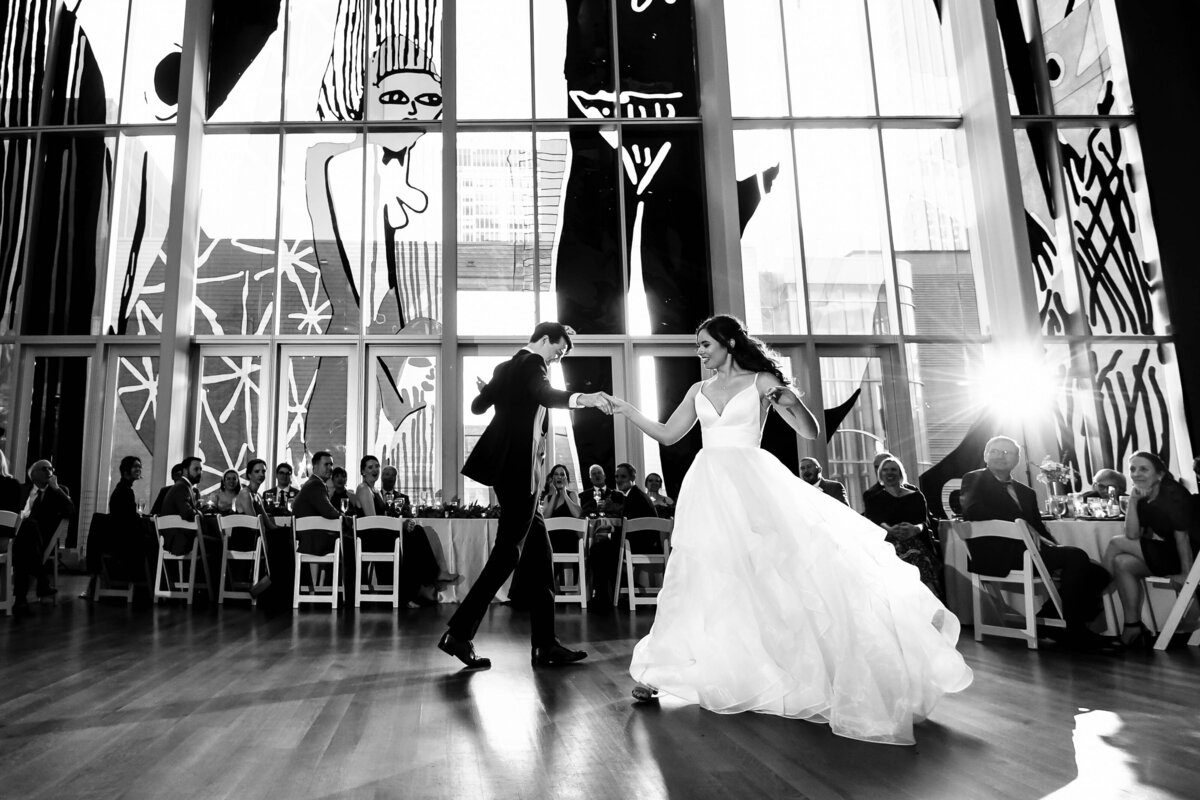 Black-and-white-photograph-of-bride-and-groom-during-their-choreographed-first-dance-at-the-Mint-Museum-Uptown