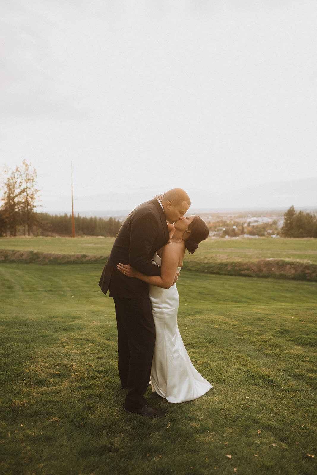 couple kisses each other during their intimate wedding sunset photos