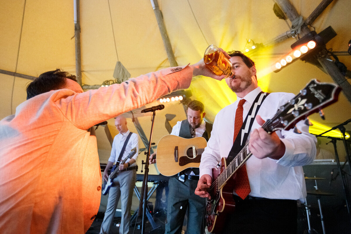 wedding band member drinking alcohol