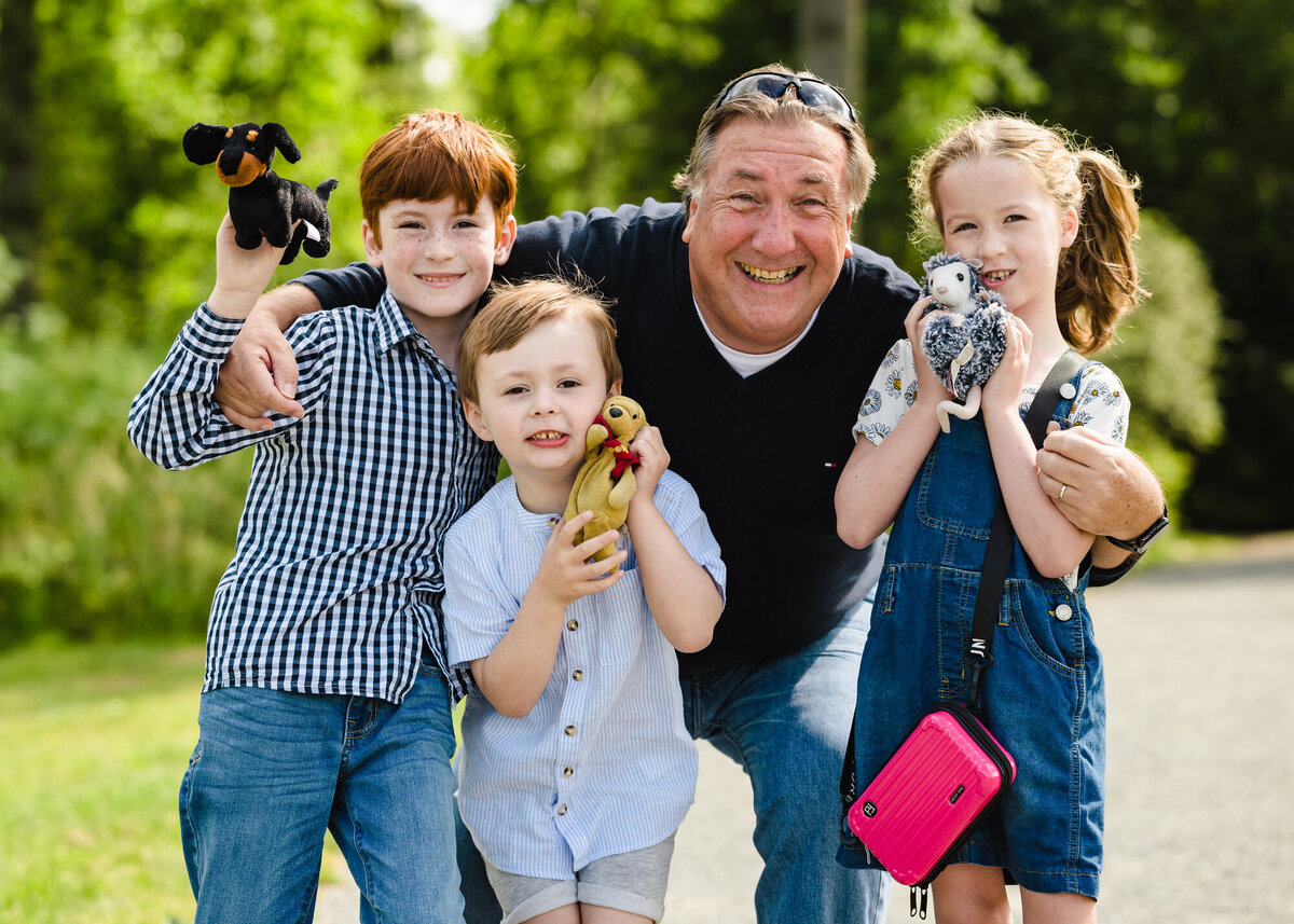 Grandad with his grandkids during family photoshoot at fineshade woods