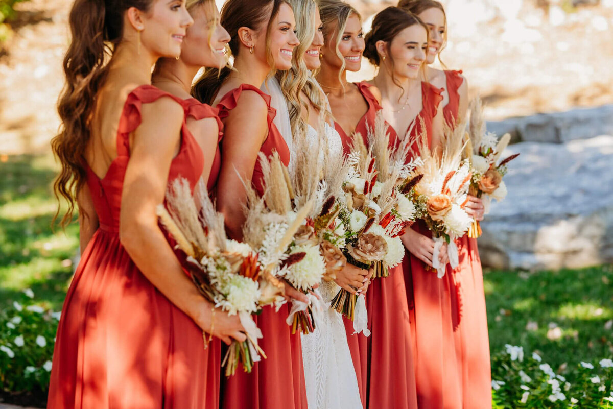 photo of a bride and bridesmaids holding boho bouquets