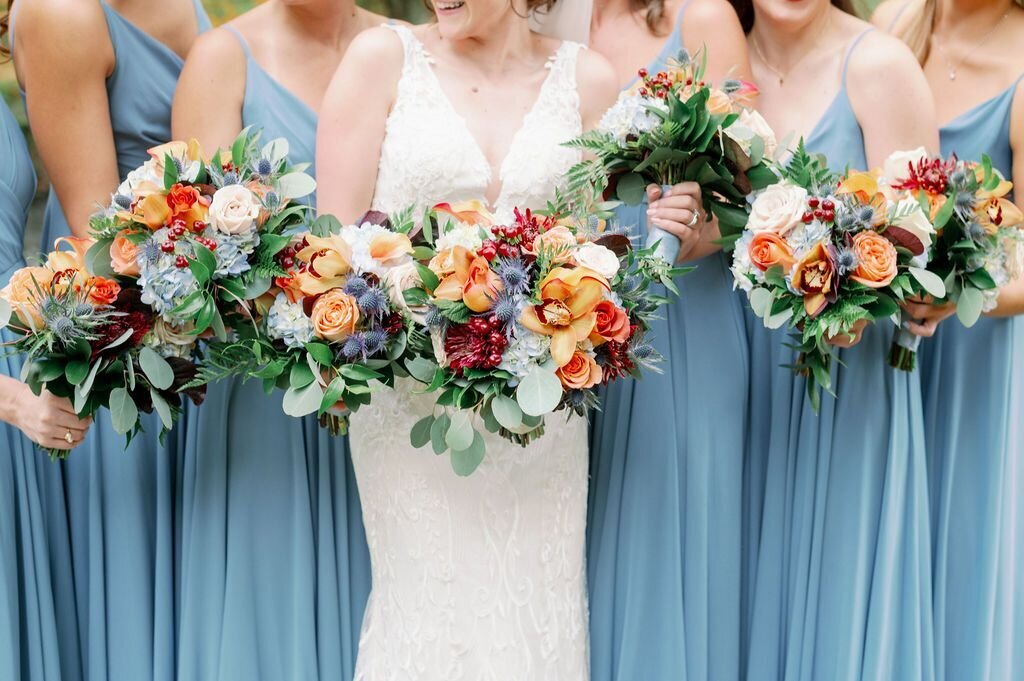 We love the tropical orchids and color palette of these bouquets! Photo Courtesy of: https://jessicakfeiden.com/
