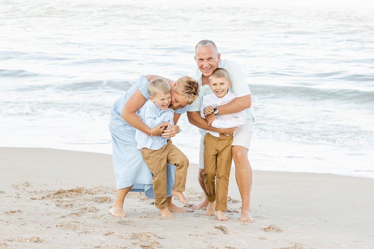Grandparents tickling their grandchildren on new Smyrna Beach
