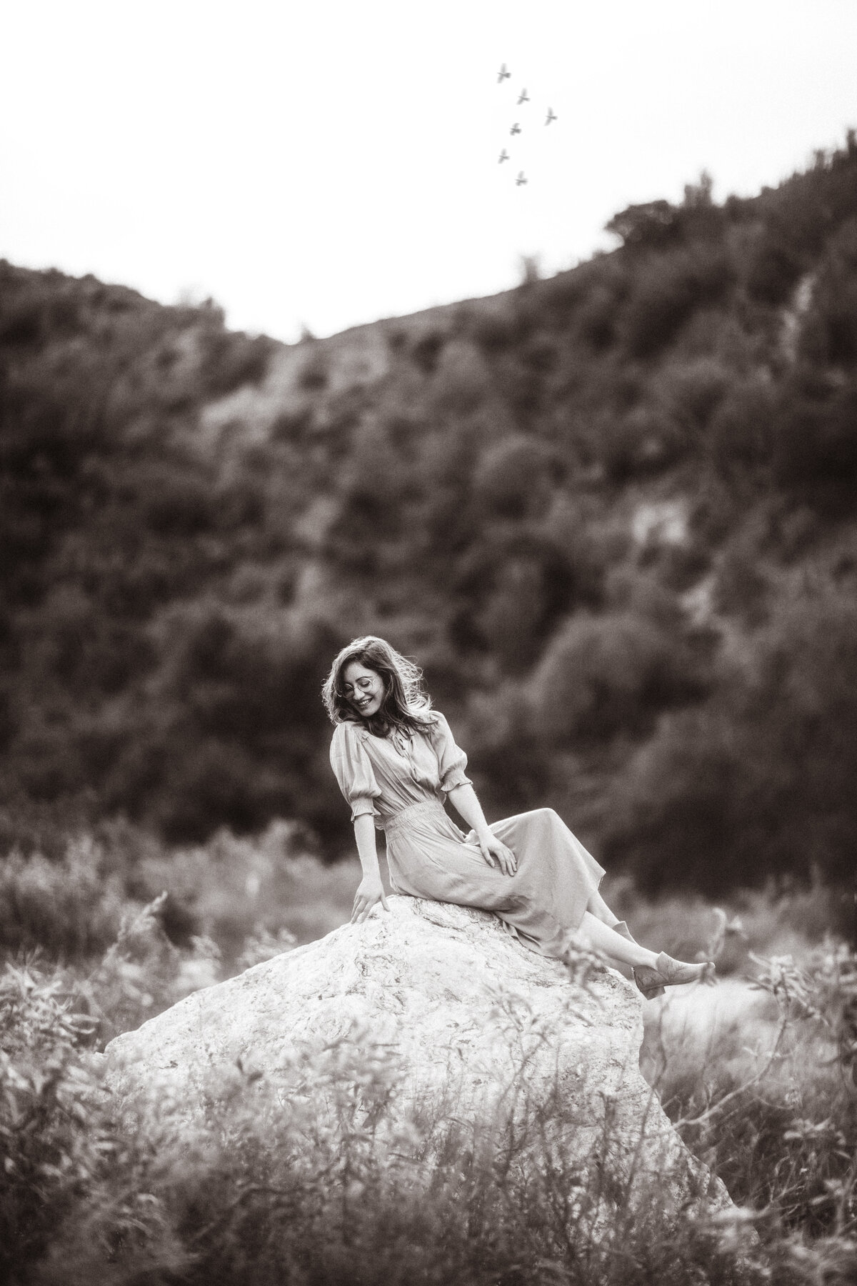 Portrait Photo Of Young Woman In Dress Seated On a Rock Black And White Los Angeles