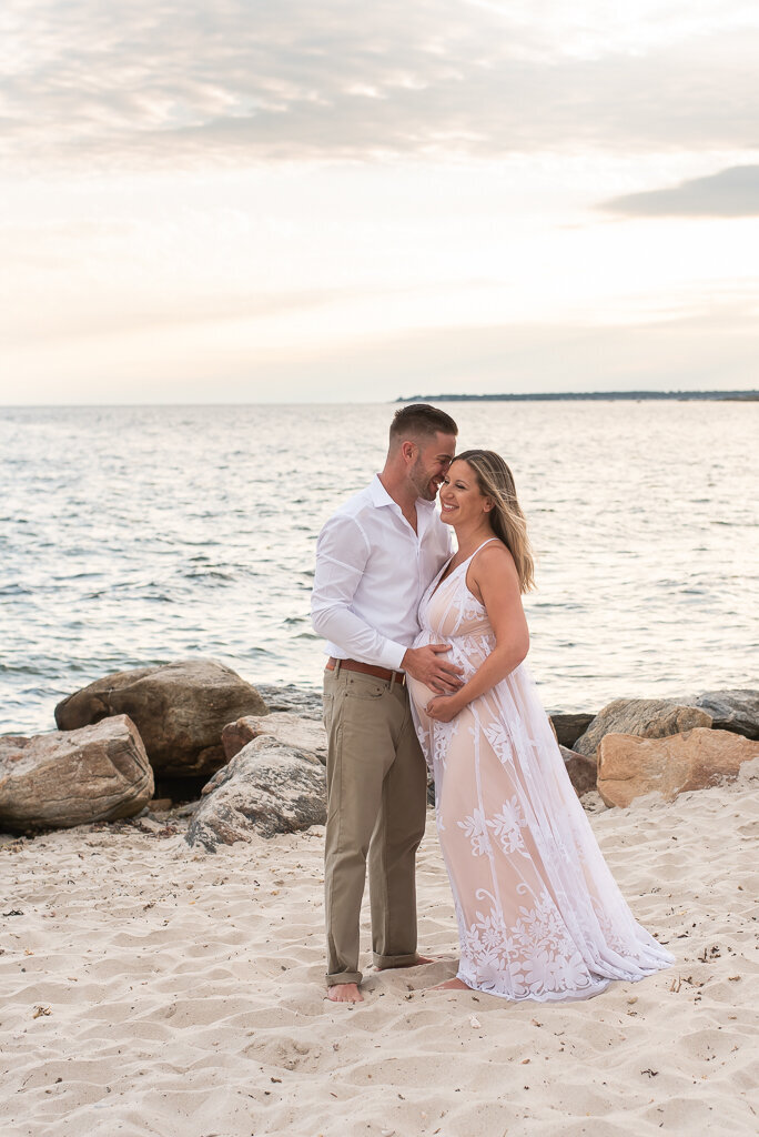 Couple kissing on the beach at sunset maternity session |Sharon Leger Photography || Canton, CT || Family & Newborn Photographer