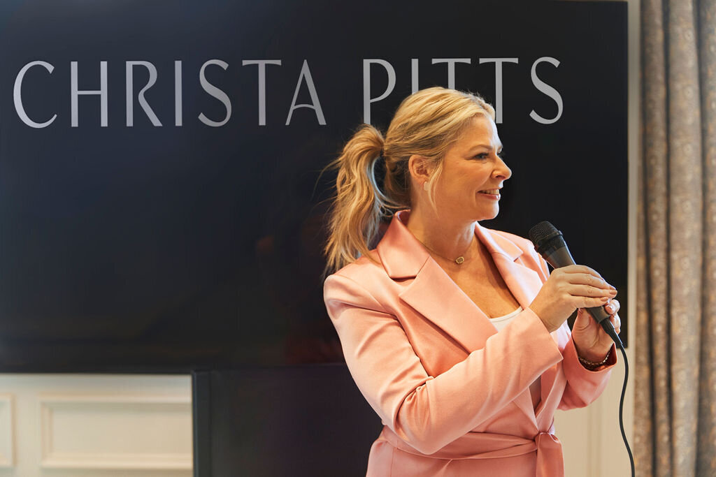 Christa Pitts speaking into a microphone