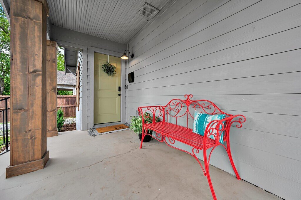 Front porch seating at this two-bedroom, one-bathroom vacation rental house for five located just 5 minutes from Magnolia, Baylor, and all things downtown Waco.