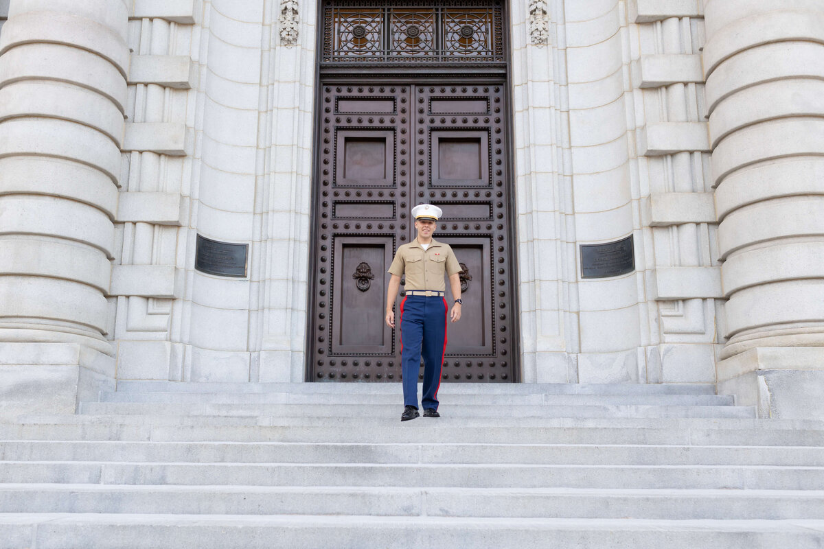 Naval Academy graduate walks steps of  Bancroft Hall.