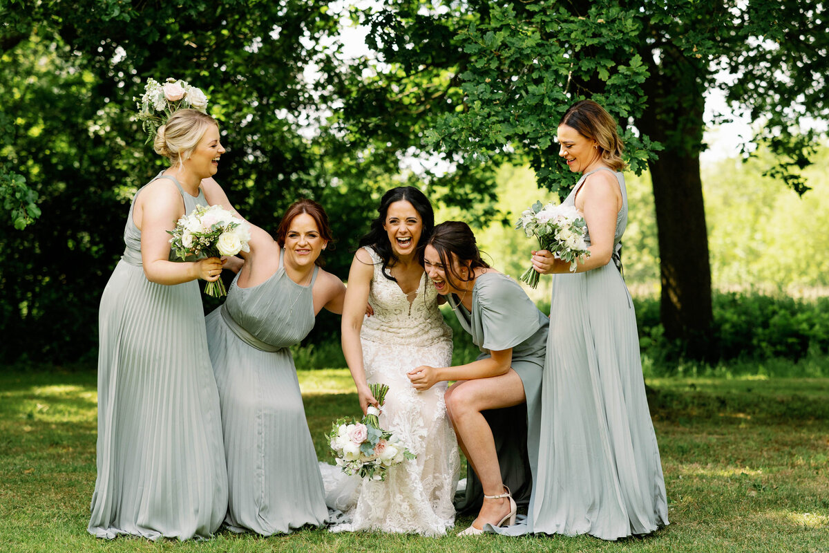 Fun, Informal photo of bride and bridesmaids laughing together