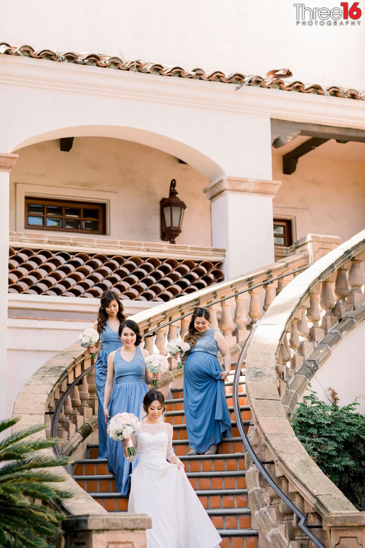 Bride and her Bridesmaids walk down the spiral staircase