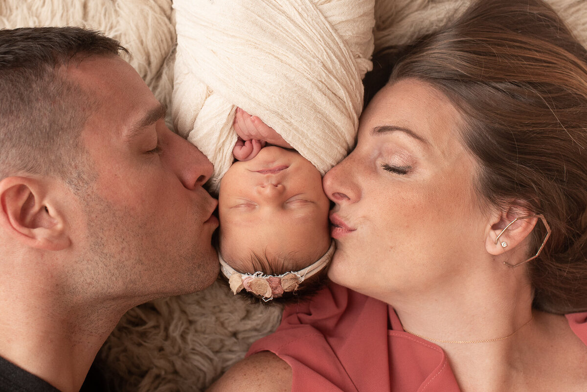 Mom and dad kissing newborn baby girl's face |Sharon Leger Photography || Canton, CT || Family & Newborn Photographer