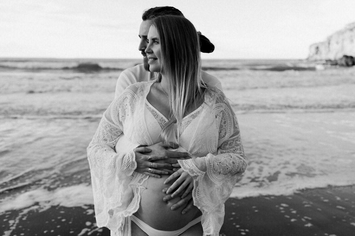 maternity taylors mistake christchurch photographer white lace dress at beach in water winter best candid