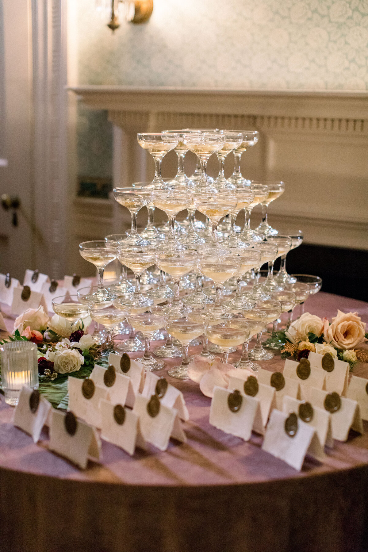 champagne tower and wedding guests place cards at wedding at Lyman Estate in Waltham Massachusetts