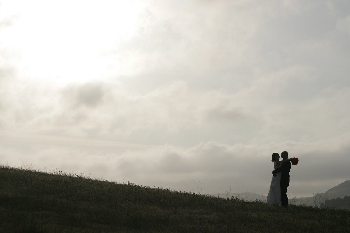 A sunset wedding portrait on a hill at Chileno Valley Ranch.