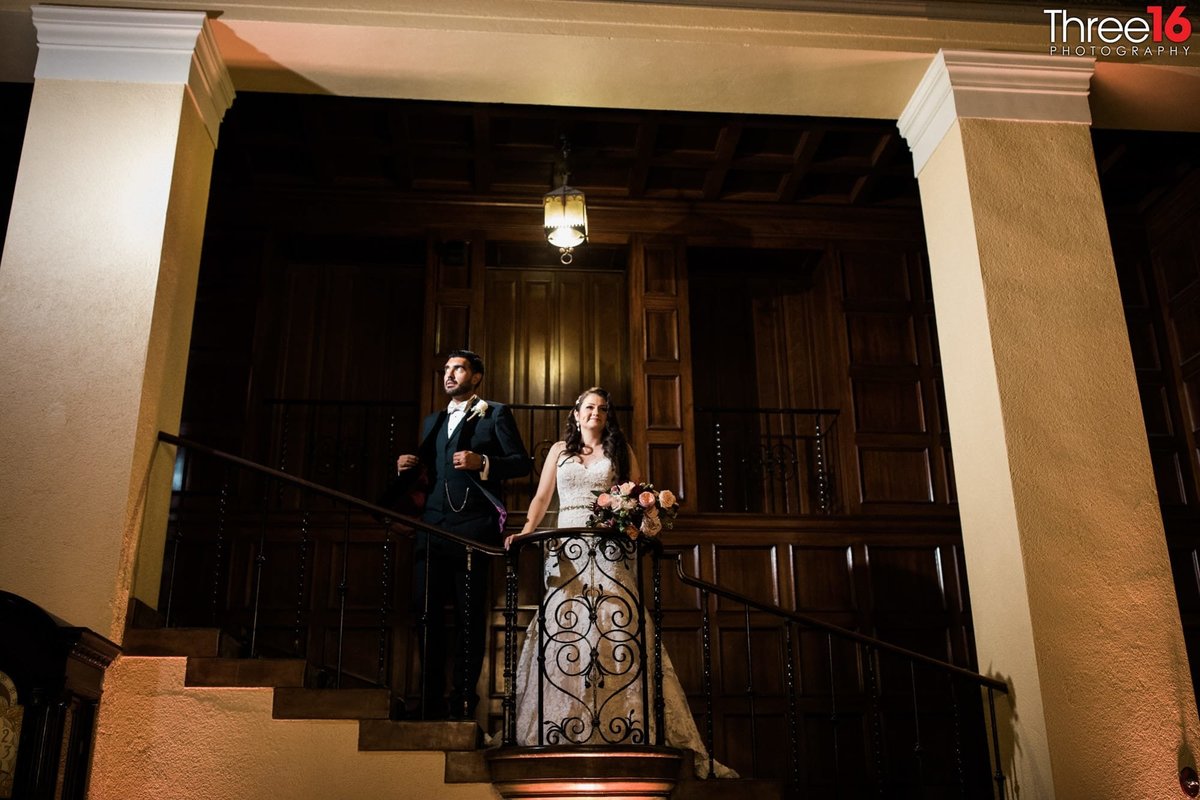 Bride and Groom pose on the classic stairwell