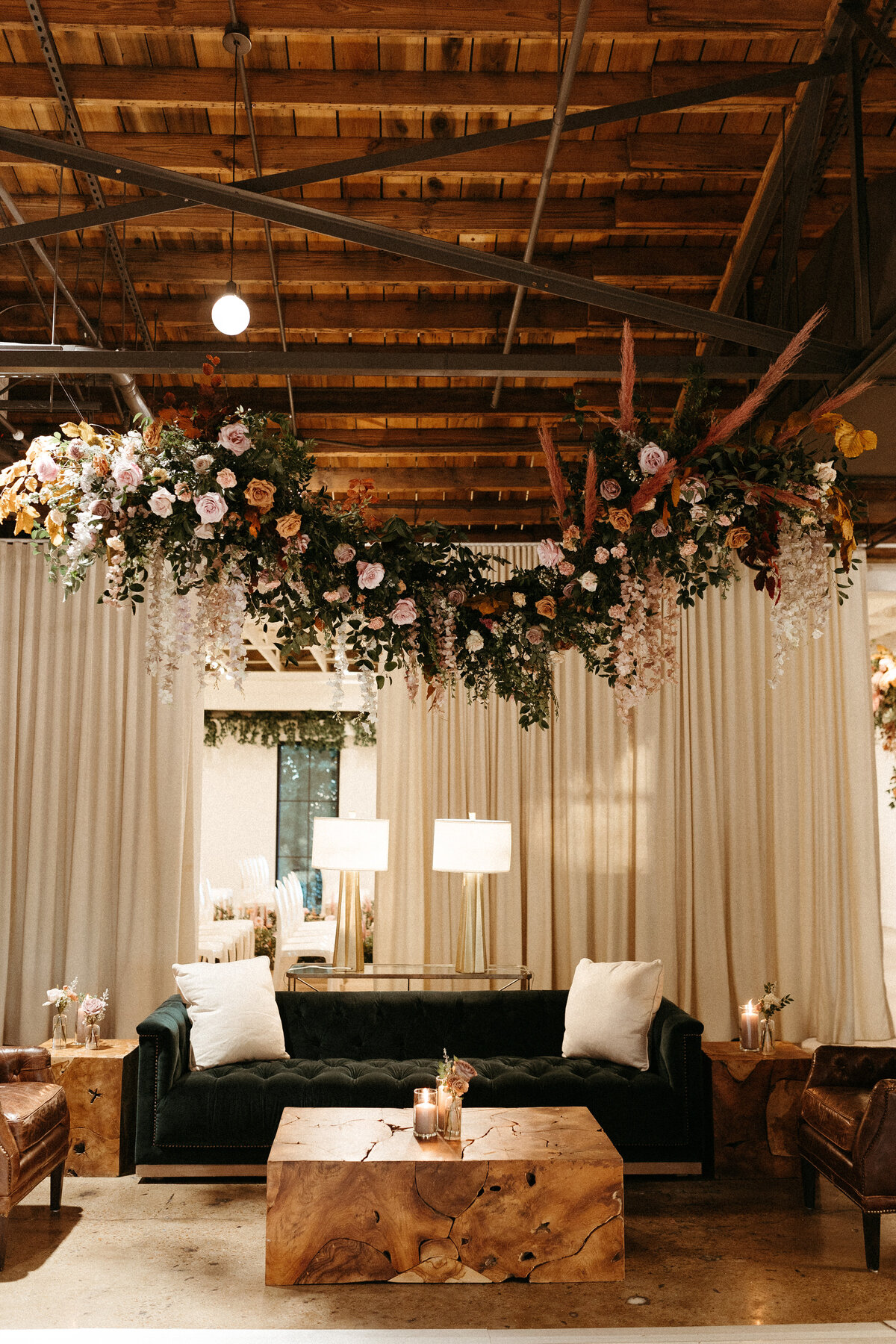 Stunning floral installations bring warmth to this Great Gatsby inspired wedding with florals of terra cotta, dusty pink, and burgundy hues. Petal heavy roses, copper beech, and pink pampas grass accents. Designed by Rosemary and Finch in Nashville, TN.